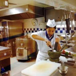 Chef Pui working a mortar and pestle